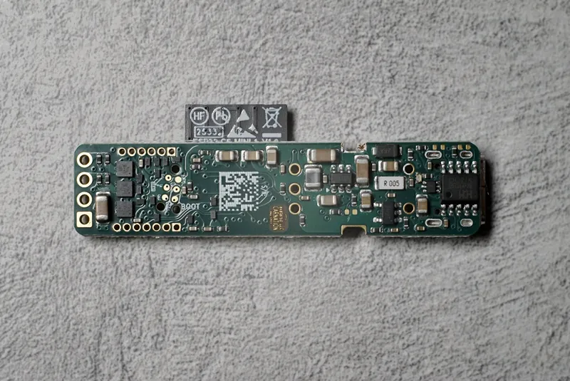 The underside, flat: the power-delivery and current-sensing parts, and the avatarsd LLC carnation mark in bare gold.